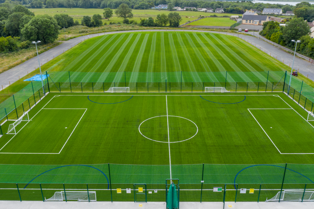Aerial view of the floodlit astro turf pitch in Lanesborough, with the grass pitch behind